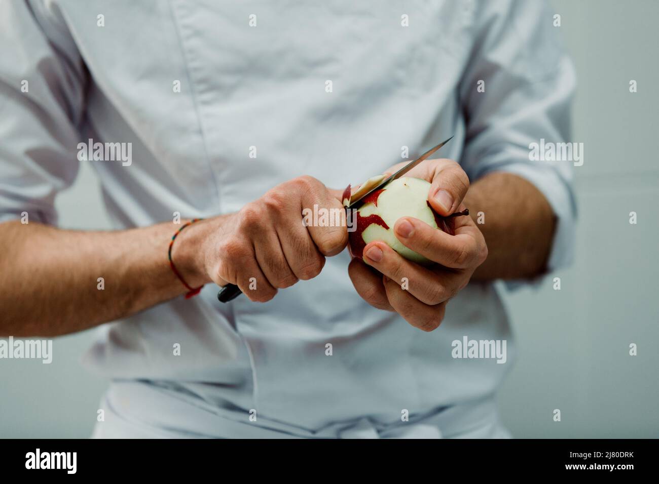 Gastronomic student peeling apples for apple pie Stock Photo