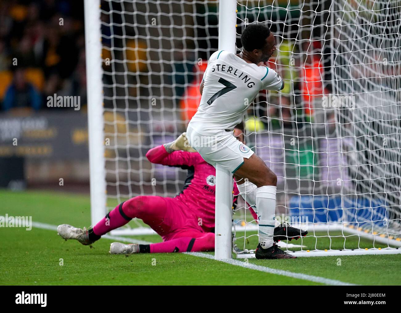 Manchester City's Raheem Sterling clashes into a post after missing a shot on goal during the Premier League match at the Molineux Stadium, Wolverhampton. Picture date: Wednesday May 11, 2022. Stock Photo