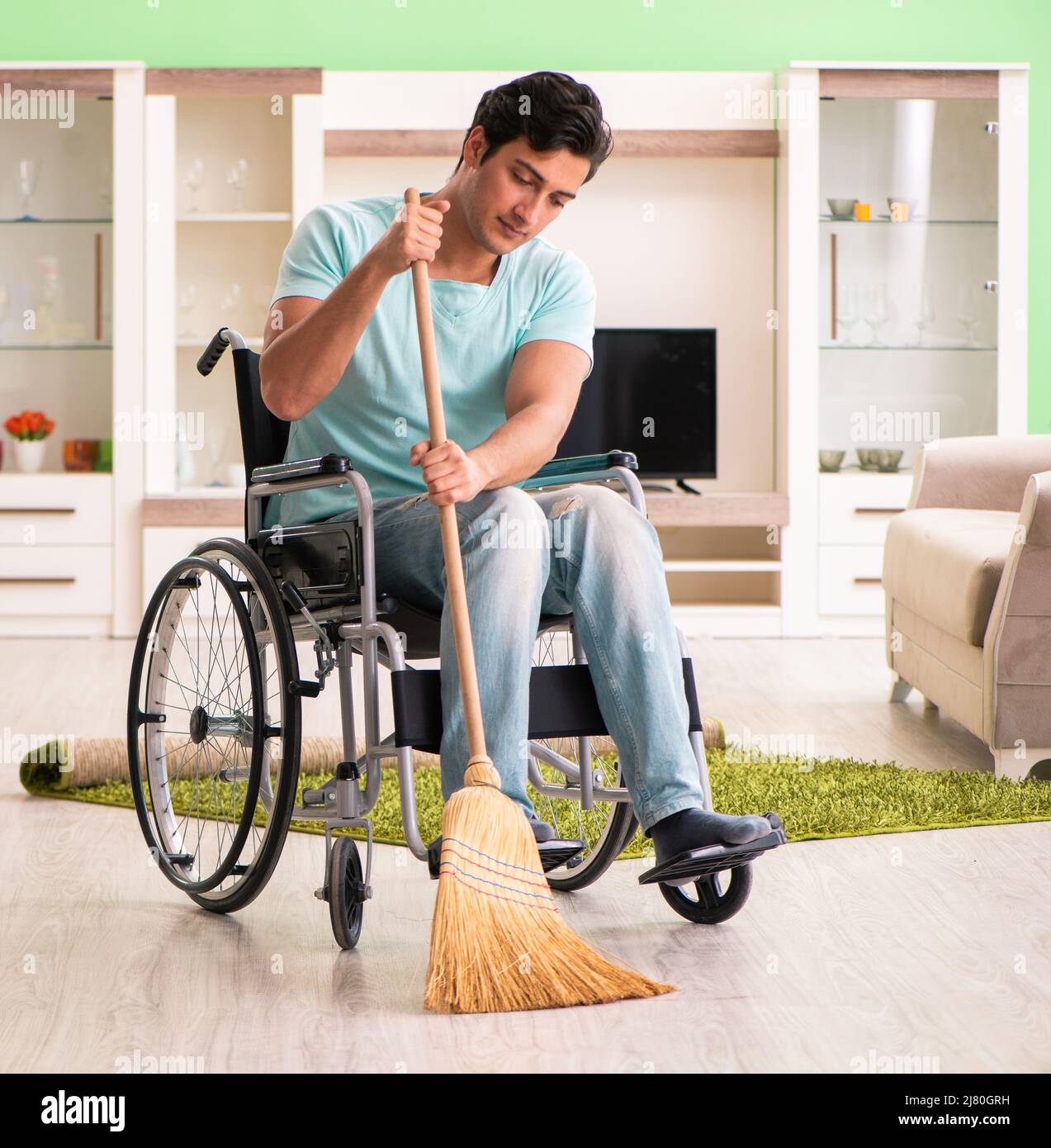 The disabled man on wheelchair cleaning house Stock Photo Alamy