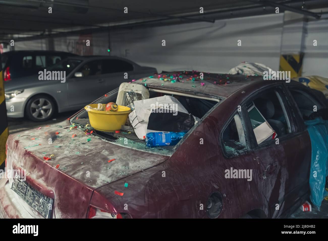 damaged car full of dust, filthy with broken screens used as a landfill