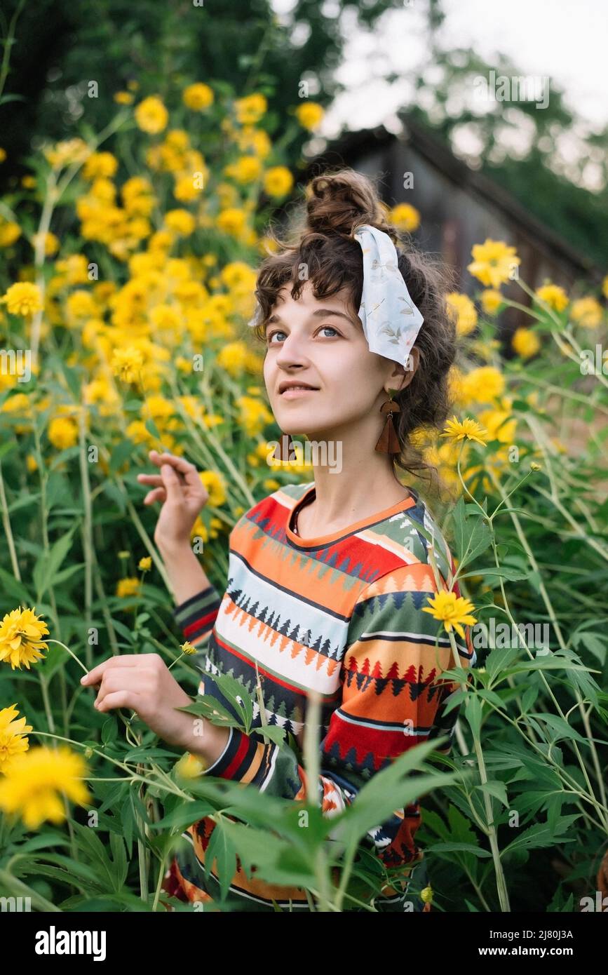 Portrait of smilling pensive hippie woman wearing colorful cloth Stock Photo