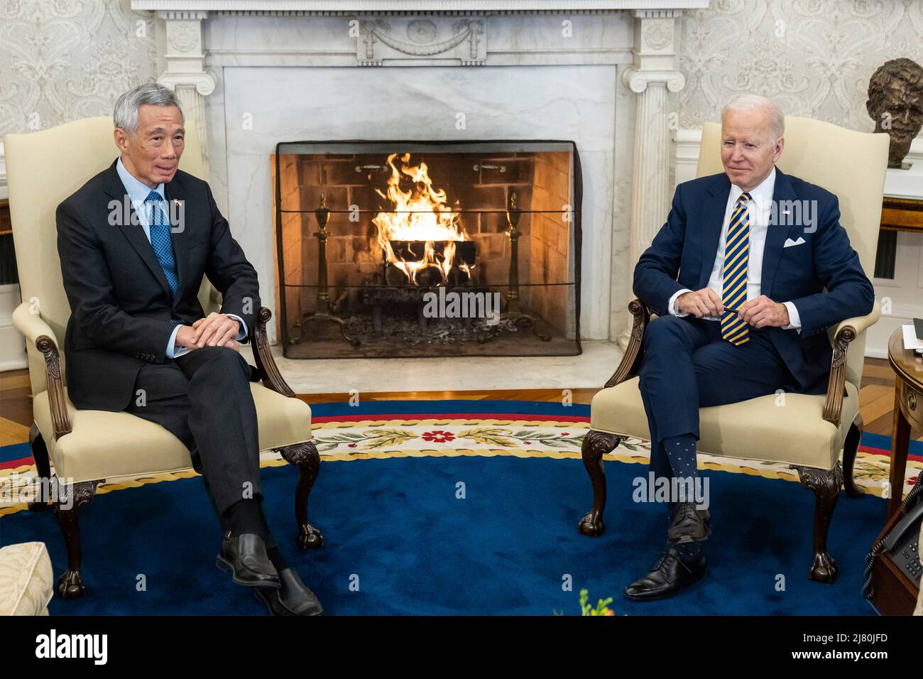 U.S President Joe Biden, holds a bilateral meeting with Singapore Prime Minister Lee Hsien Loong, left, in the Oval Office of the White House, March 29, 2022 in Washington, D.C. Stock Photo