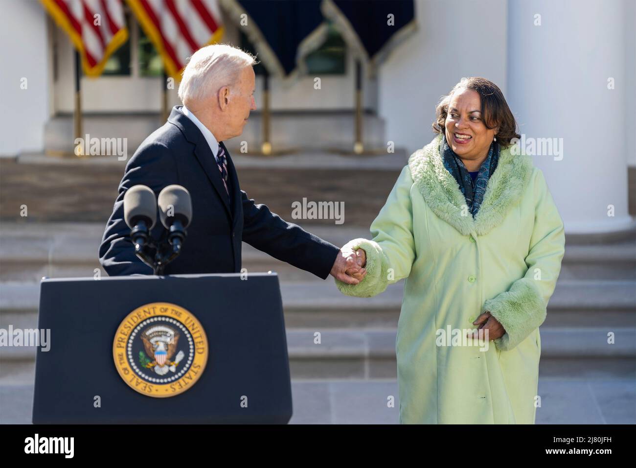 U.S President Joe Biden, reaches out to Michelle Duster, great granddaughter of NAACP co-founder Ida B. Wells, during the signing ceremony for H.R. 55, the Emmett Till Anti-lynching Act, in the Rose Garden of the White House, March 29, 2022 in Washington, D.C. Stock Photo