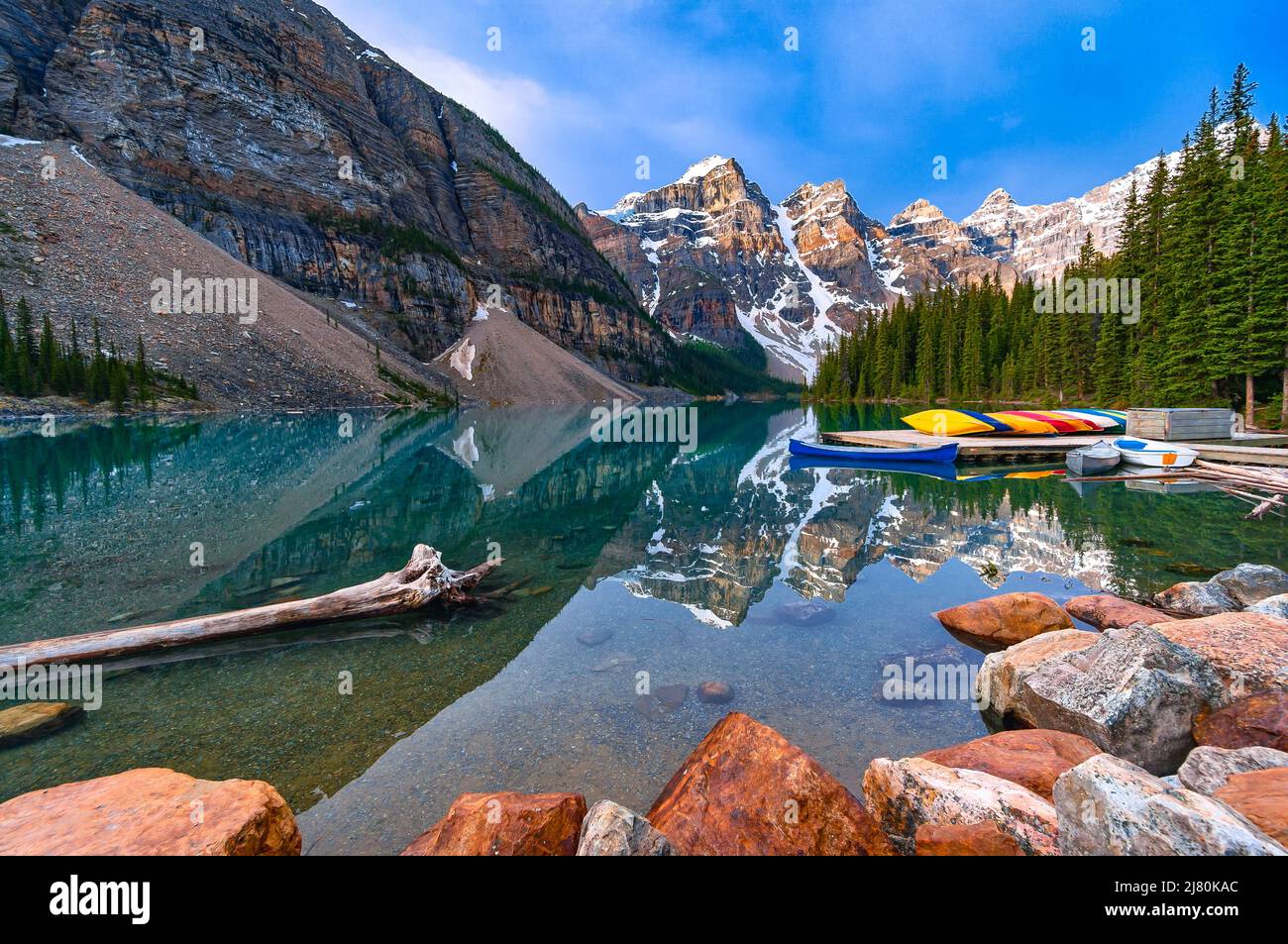Moraine Lake reflection and canoes, Canadian Rockies, Banff National Park, Alberta, Canada Stock Photo