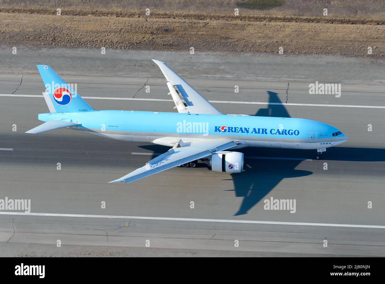 Korean Air Cargo Boeing 777 plane landing. Airplane 777 cargo. Freighter aircraft of KoreanAir Cargo landing deploying reverse thrust and slats. Stock Photo