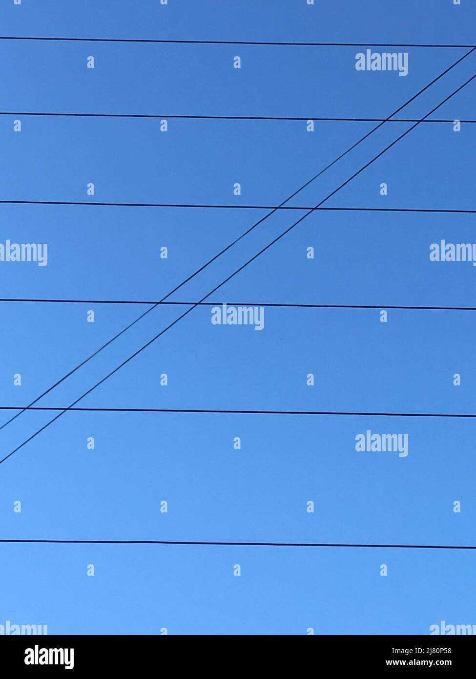 Electric wires on a blue sky Stock Photo