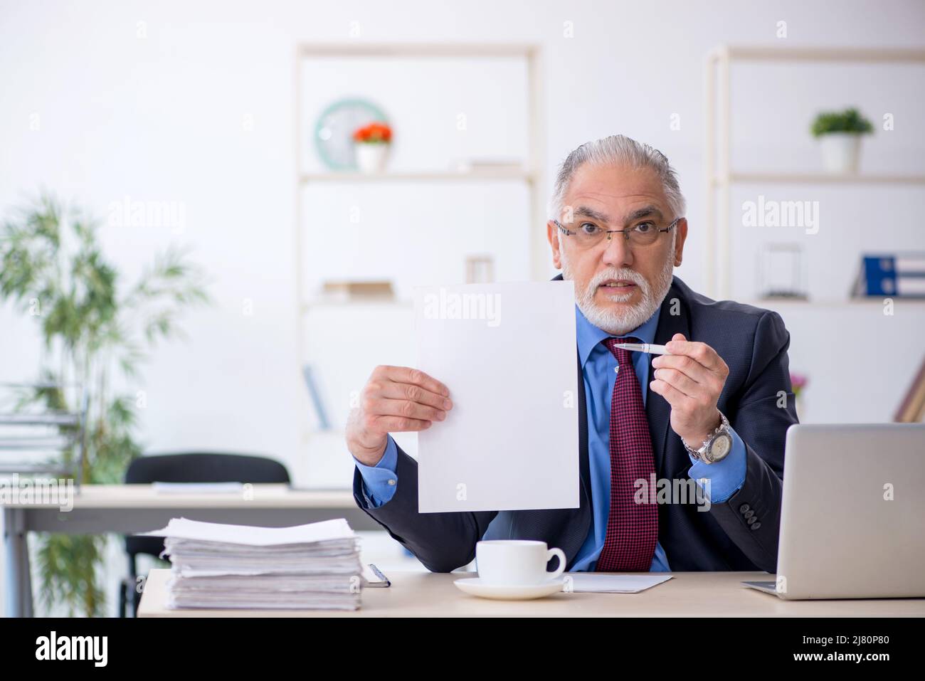 Old businessman employee working at workplace Stock Photo - Alamy