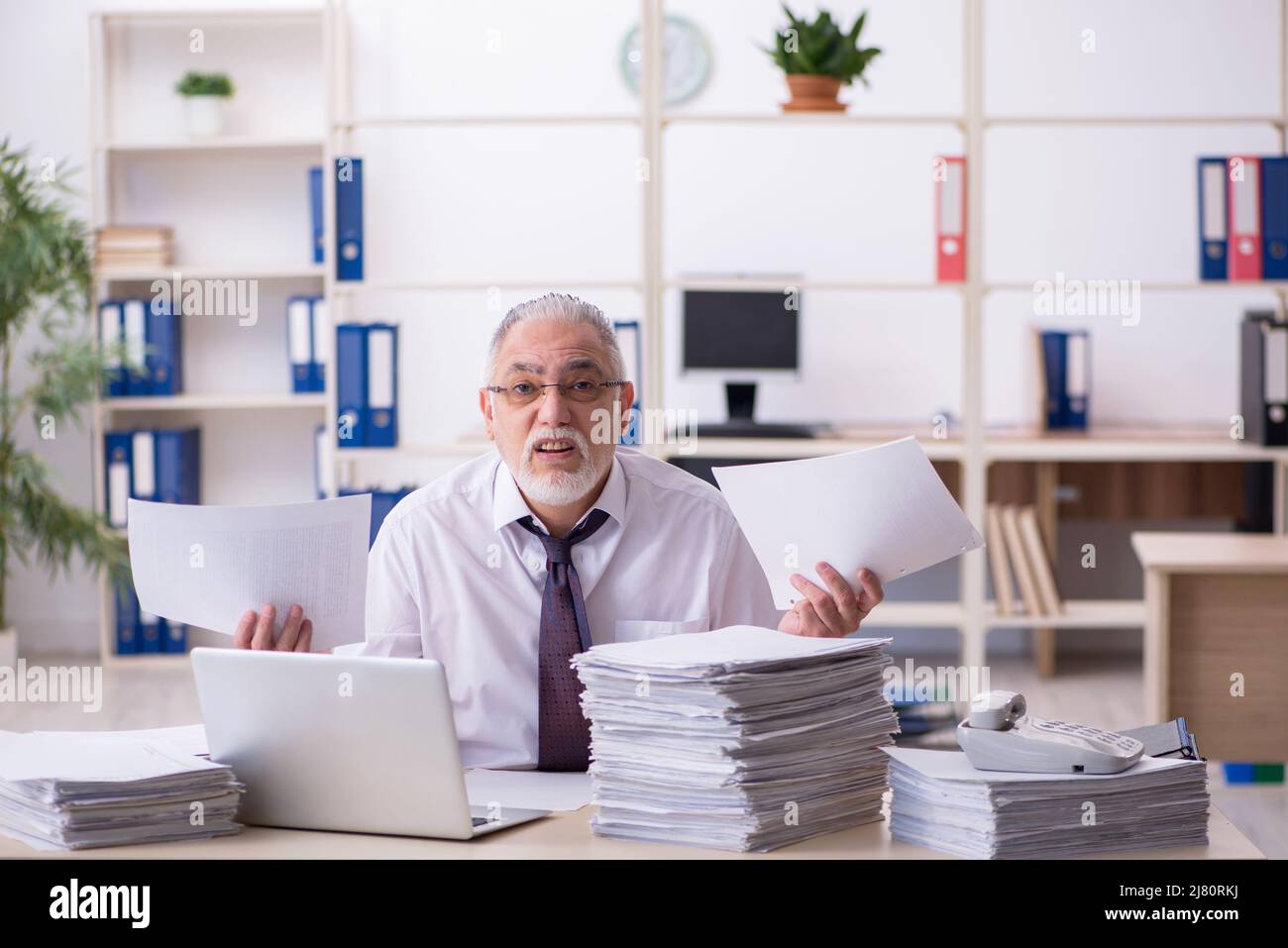 Old employee and too much work in the office Stock Photo Alamy