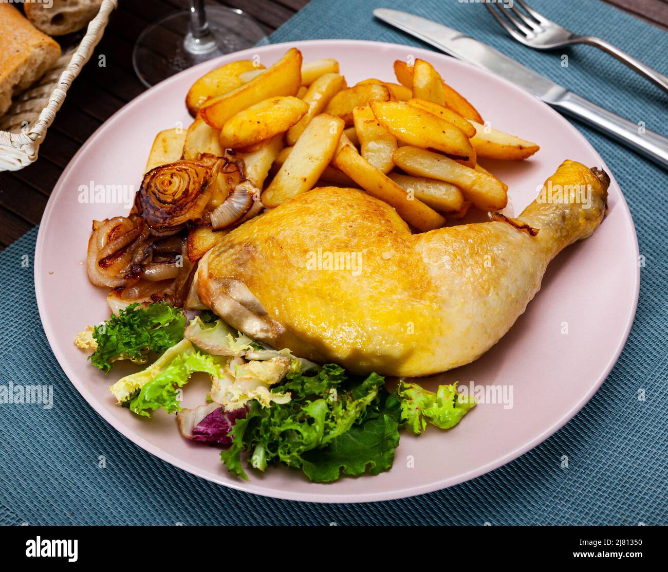 Baked chicken legs with potatoes Stock Photo - Alamy