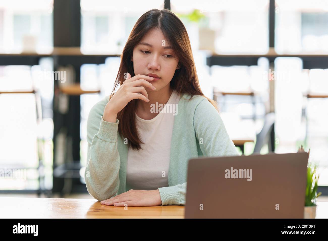 Frustrated young woman have problem while sitting at her working place. Business Stressed concept. Stock Photo