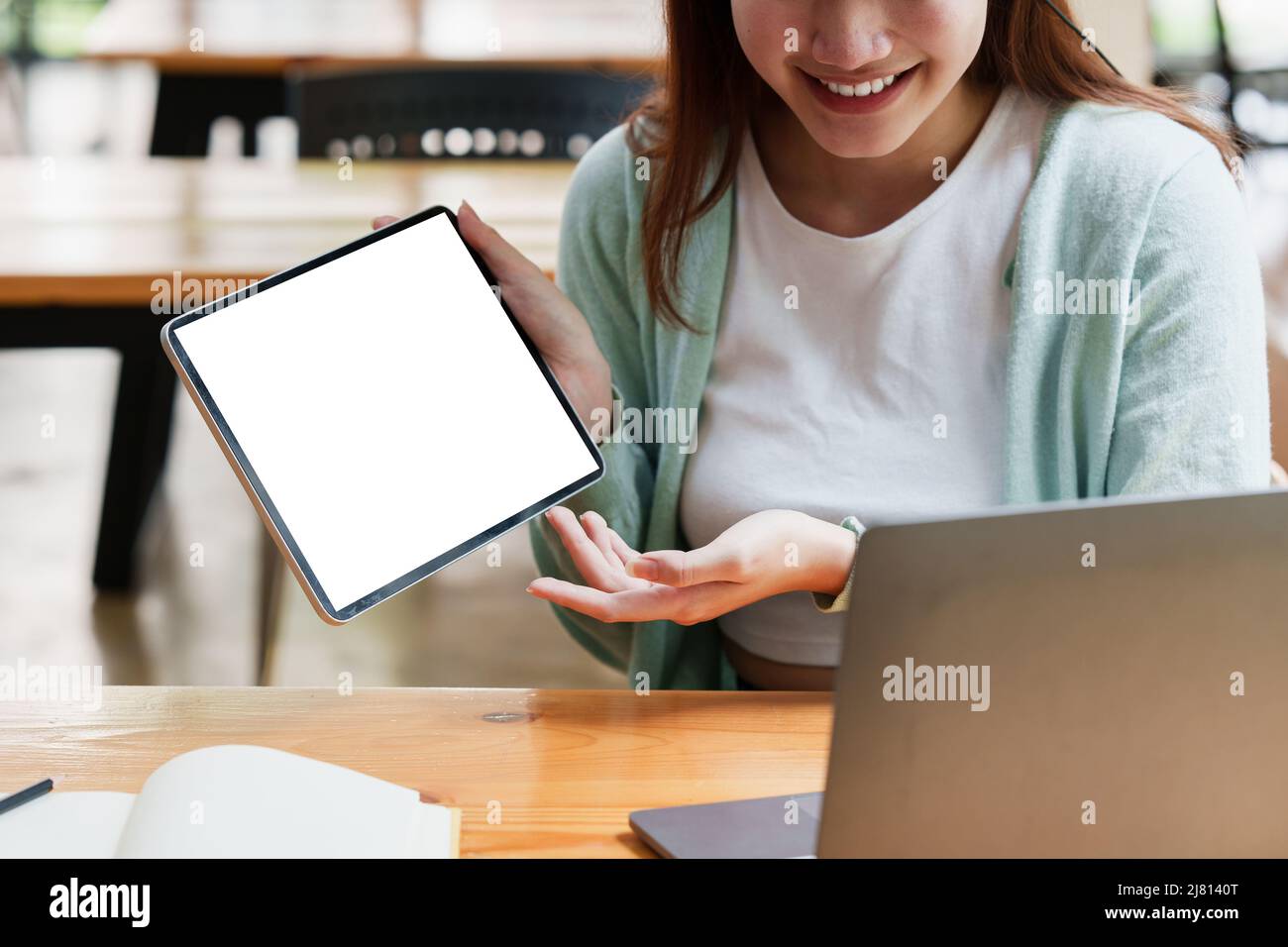Smiling Asian attentive student studying online class. e-learning education concept. Stock Photo
