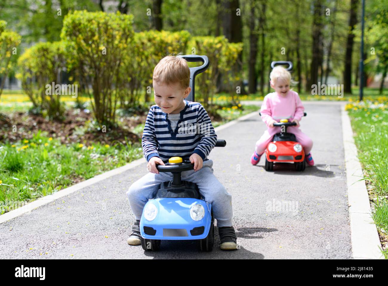 Kids Are Playing With a Toy Car Outdoors in the Park - A Happy Boy and ...