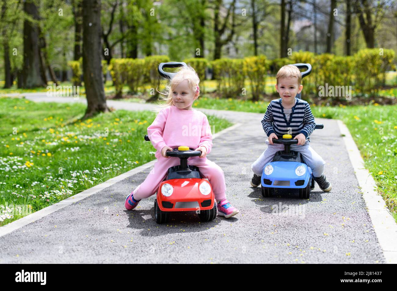 Kids Are Playing With a Toy Car Outdoors in the Park - A Happy Boy and ...