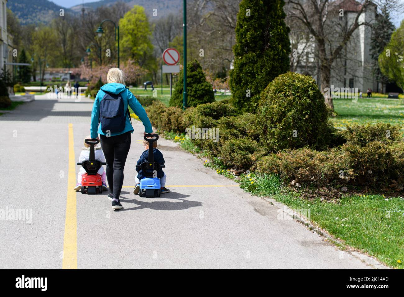 Mom and Kids Are Playing With a Toy Car Outdoors in the Park - A Happy ...