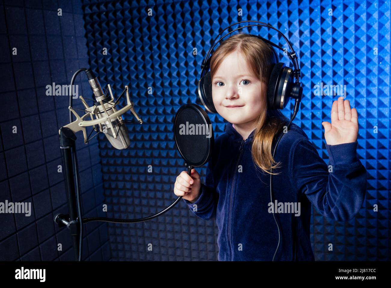 girl star singer artist in a black blouse with headphone recording new song  with microphone Stock Photo - Alamy