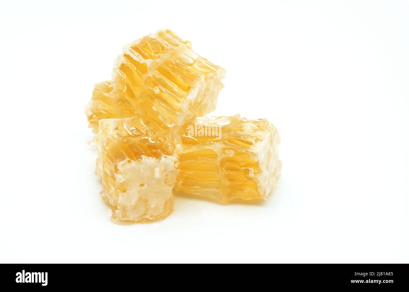 Isolated small pile of honeycomb on white background, macro juicy honeycombs. Stock Photo