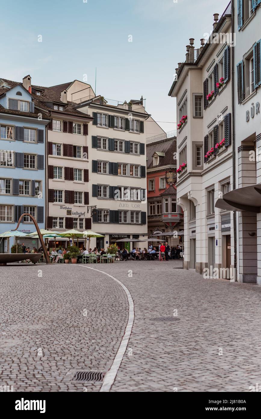 Zurich Switzerland. 5. July 2018 Münsterhof, square next to Fraumunster church with cobbled pavement, colorful buildings and modern fountain. Stock Photo