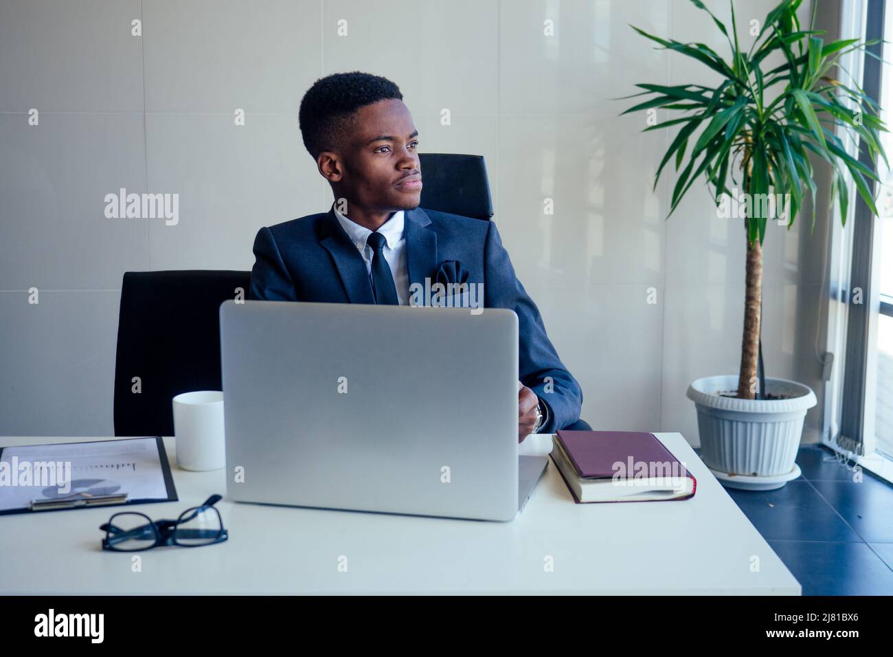 Handsome cheerful african american in a modern office with a panoramic window Stock Photo