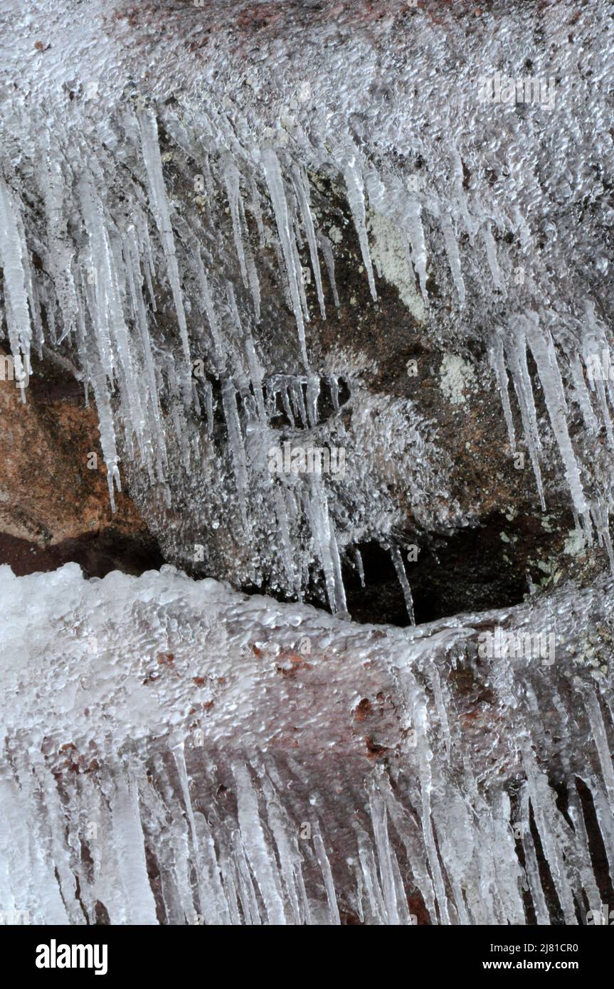 Melting icicles on sandstone rocks with lichen at Red Rocks Park in Morrison Colorado Stock Photo