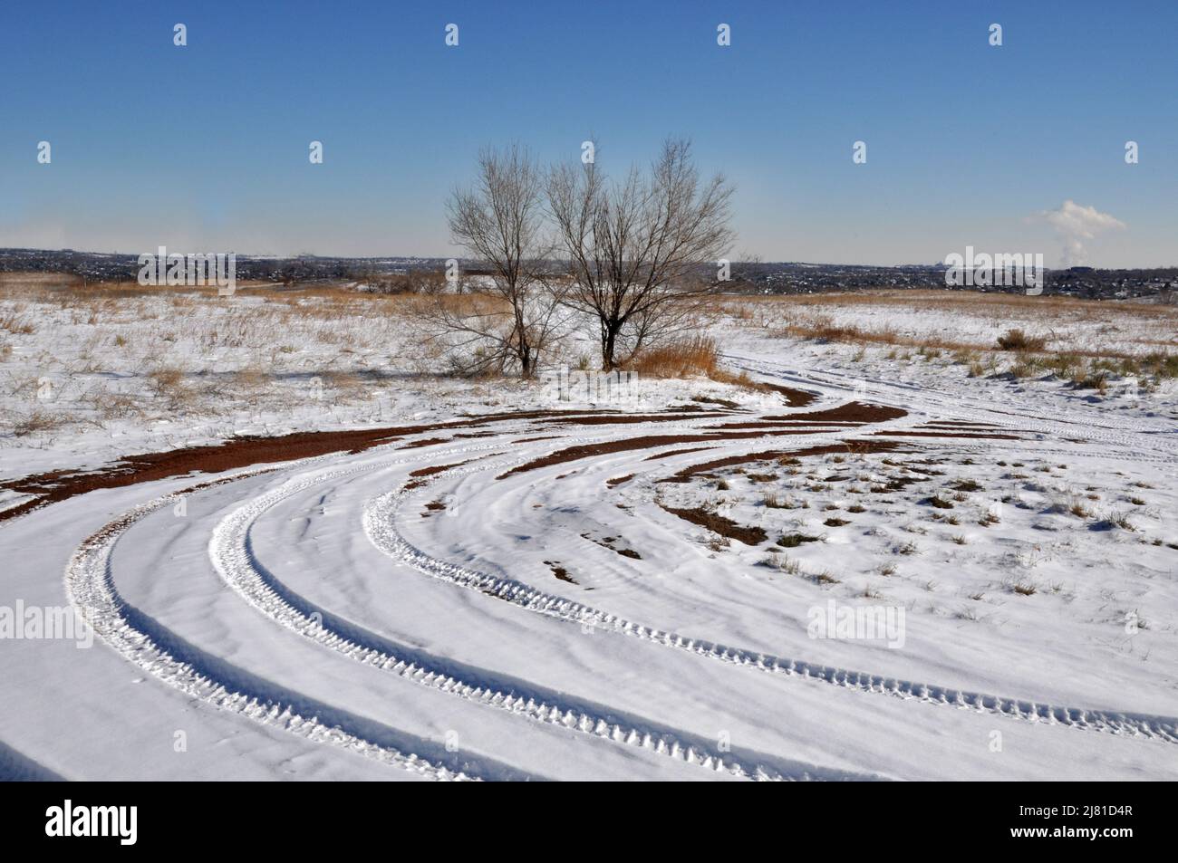Winter landscape with vehicle tracks in snow Stock Photo