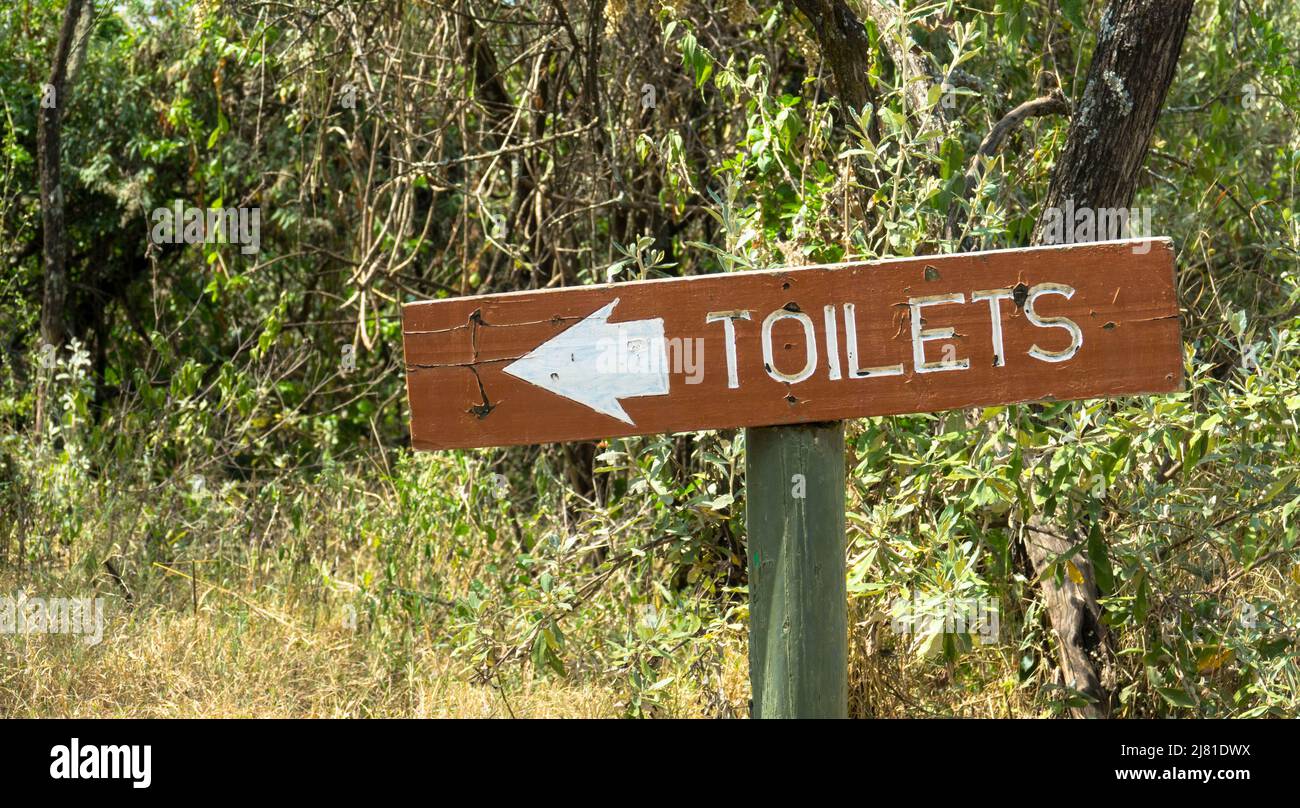 Path to the bush toilet, Masai Mara Wildlife Reserve. Wooden sign with