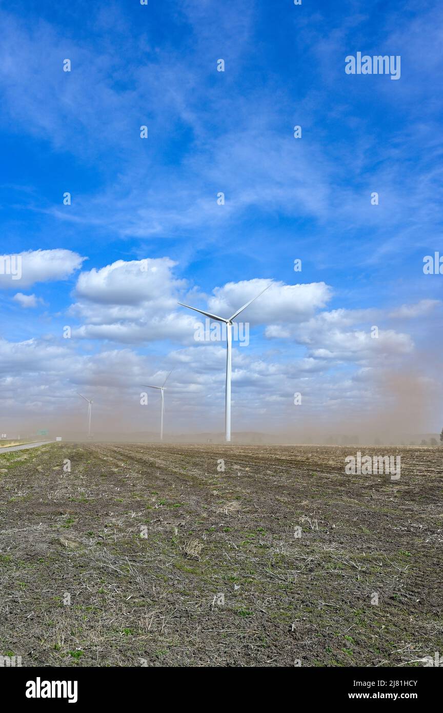 soil and dirt blowing over field with wind turbines Stock Photo Alamy