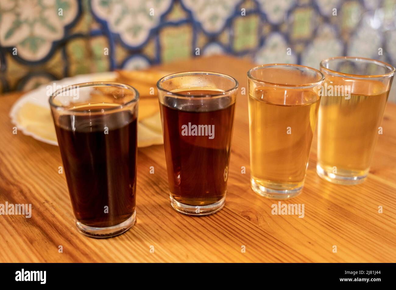 Tasting of different sweet wines from wooden barrels on old bodega wine