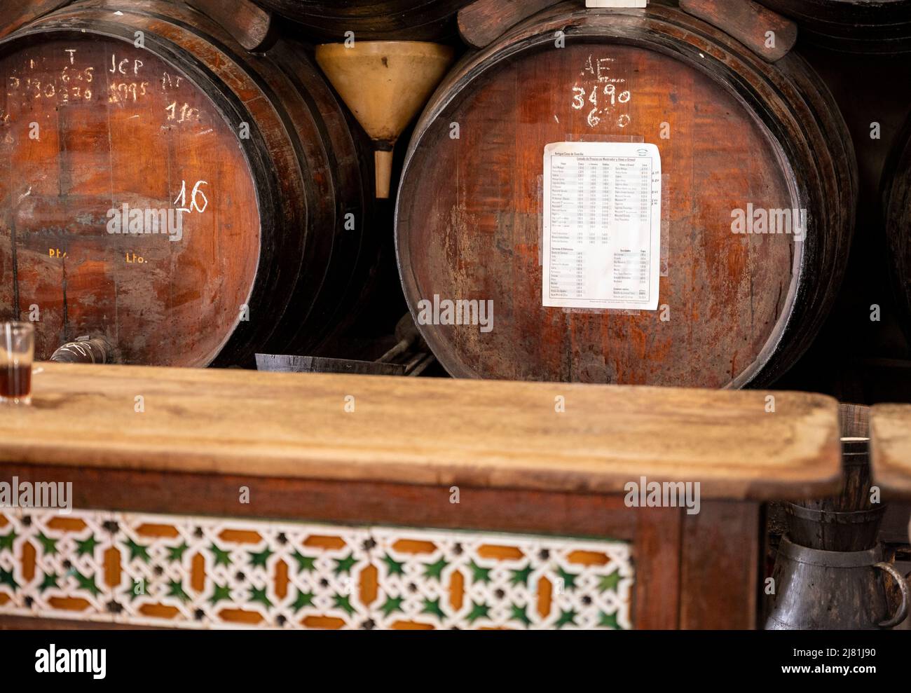 Tasting of different sweet wines from wooden barrels on old bodega wine