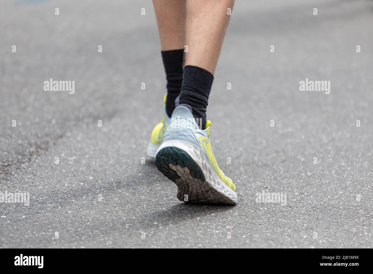 black socks in running shoes on asphalt Stock Photo