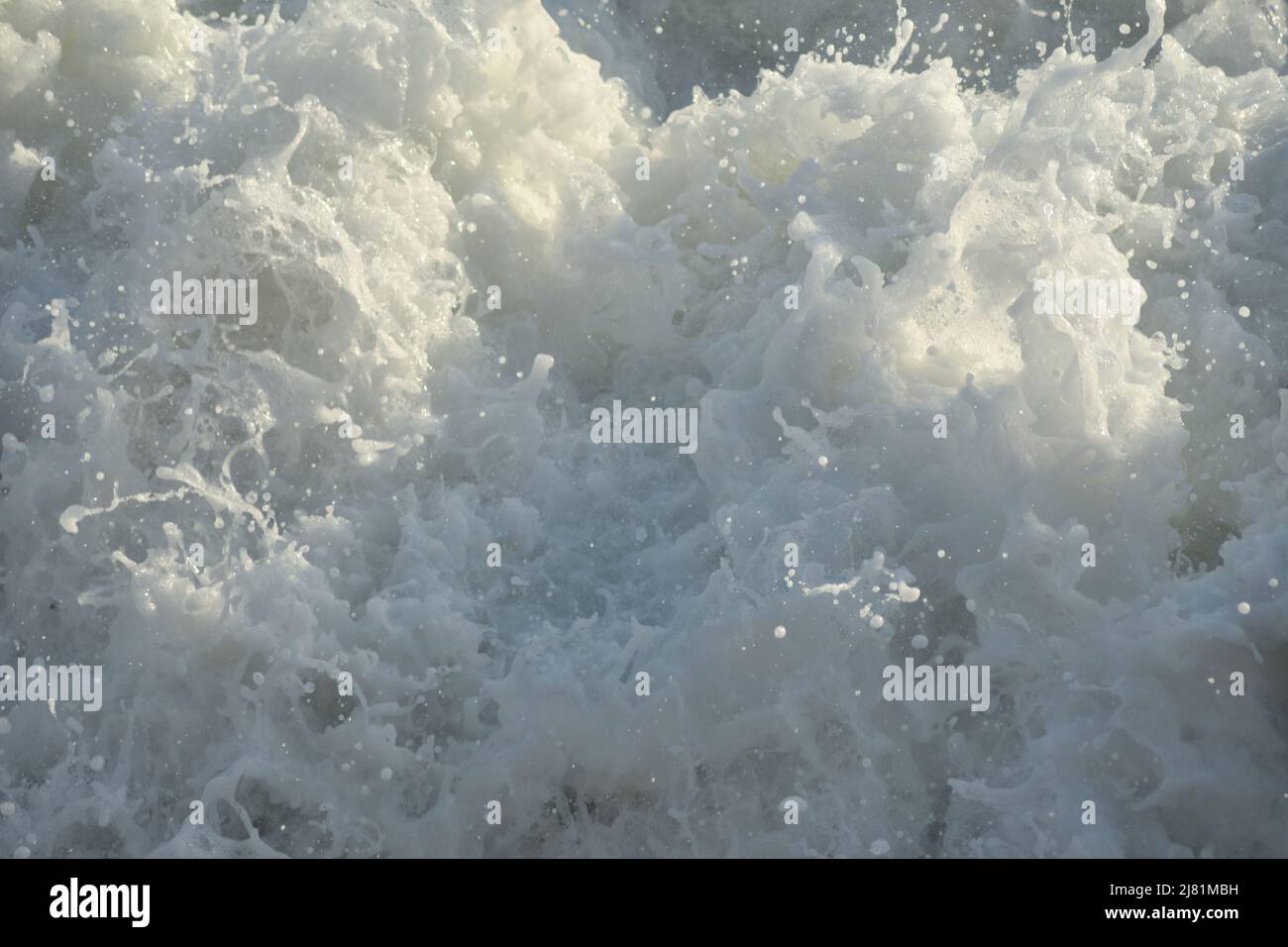 Waves sea with white foam entering with force Stock Photo - Alamy