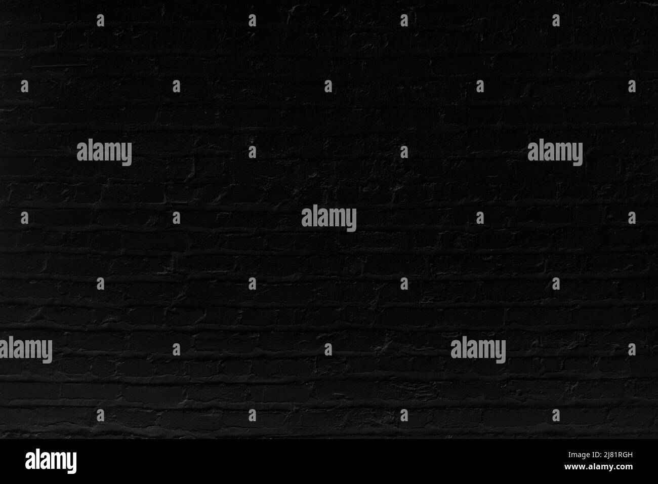 Black brick wall with top illumination effect. Background photo texture Stock Photo