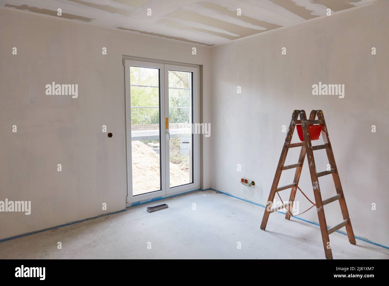 Head stands for painting work on wall in room at house new construction project Stock Photo