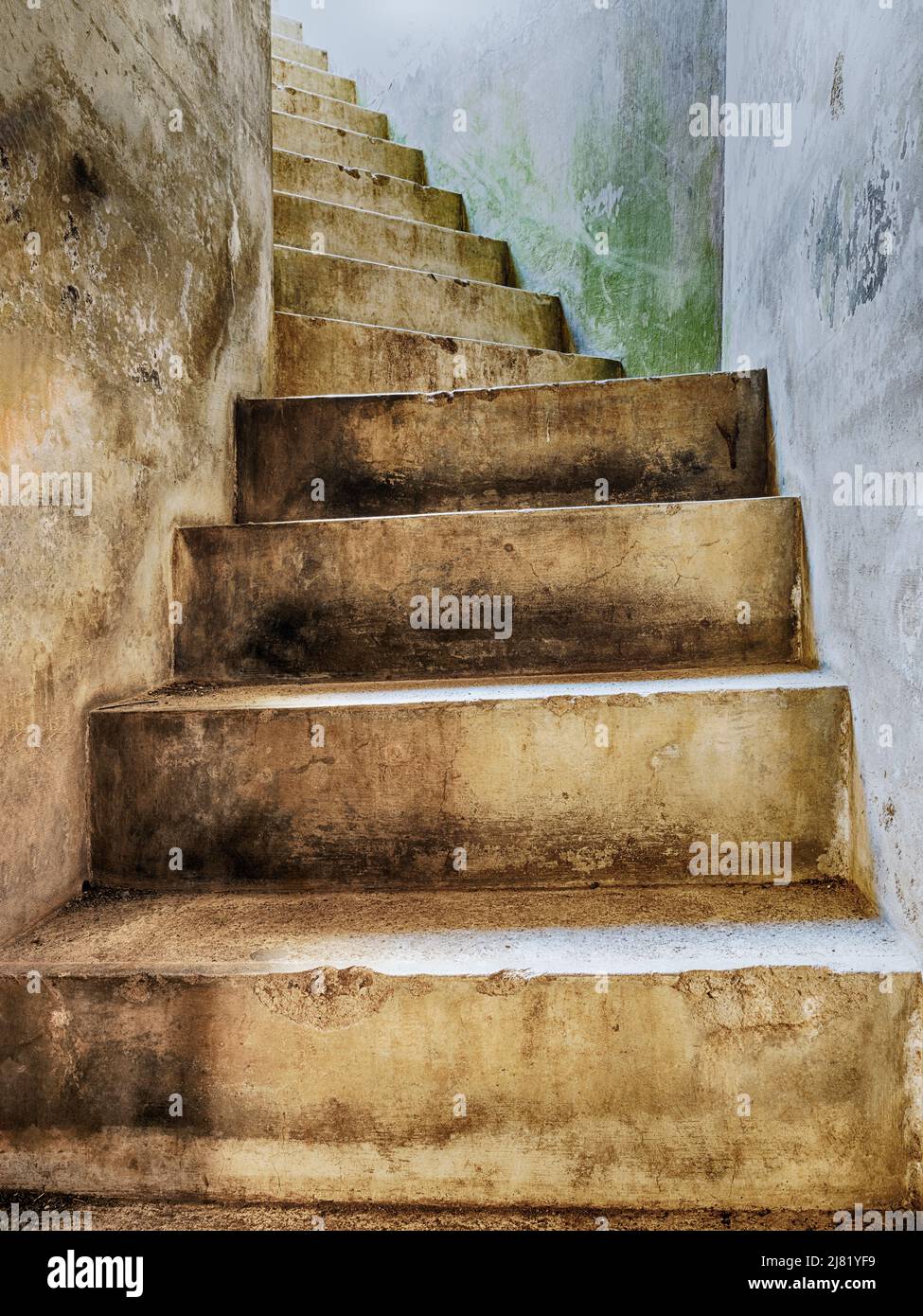 Concrete stairs from the basement rooms at Fort Casey lead upwards to the light. Stock Photo