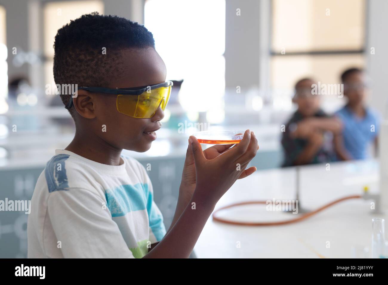 African american elementary schoolboy performing scientific experiment ...