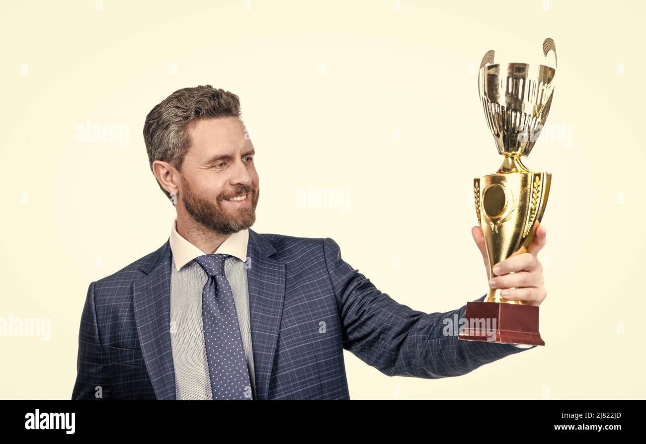 Proud manager in formalwear hold golden cup for business achievement isolated on white, pride Stock Photo