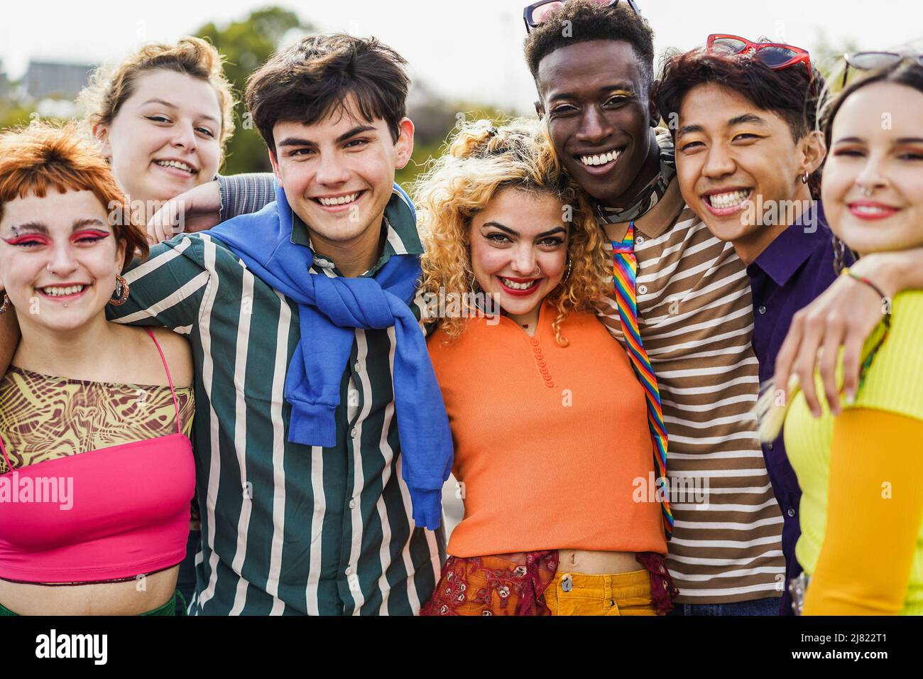 Young diverse people having fun outdoor laughing together - Focus on ...