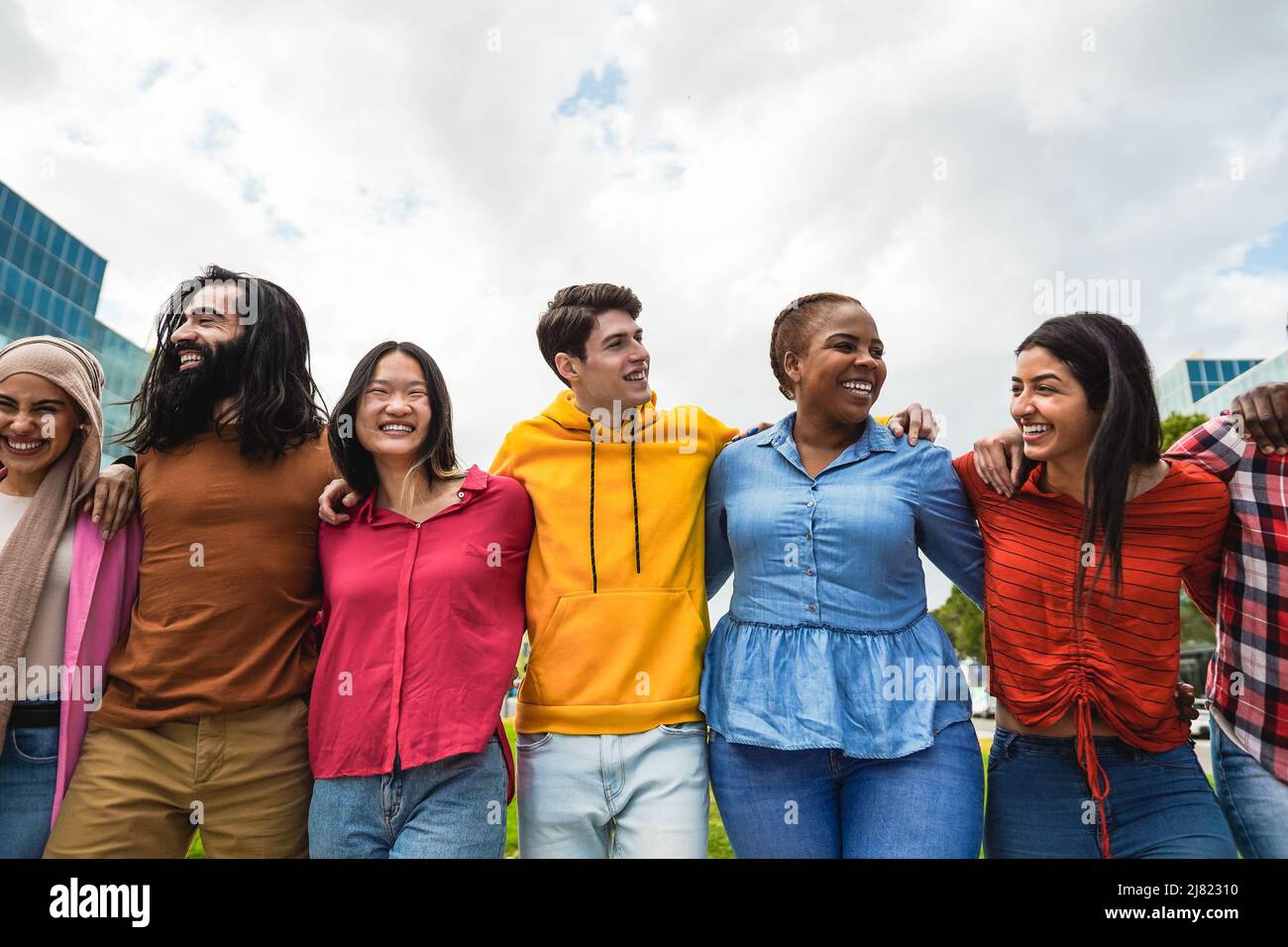 Young diverse people having fun walking together outdoor - Focus on ...