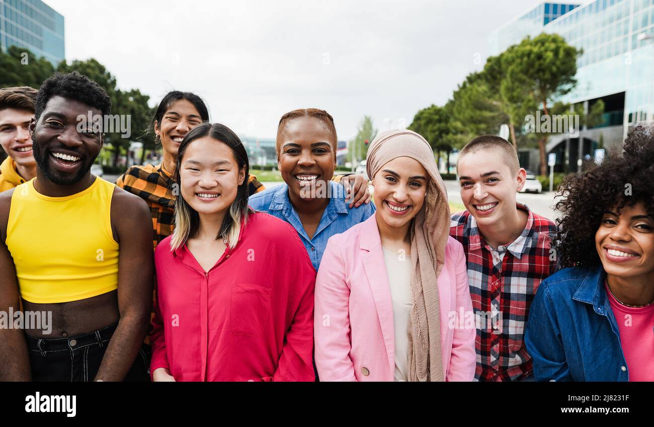 Young diverse people having fun outdoor laughing together - Focus on ...