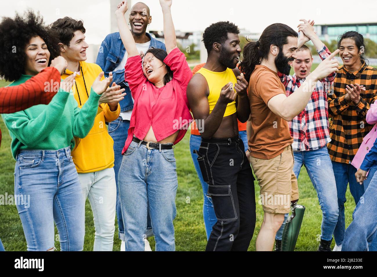 Young diverse people having fun outdoor dancing together - Focus on ...