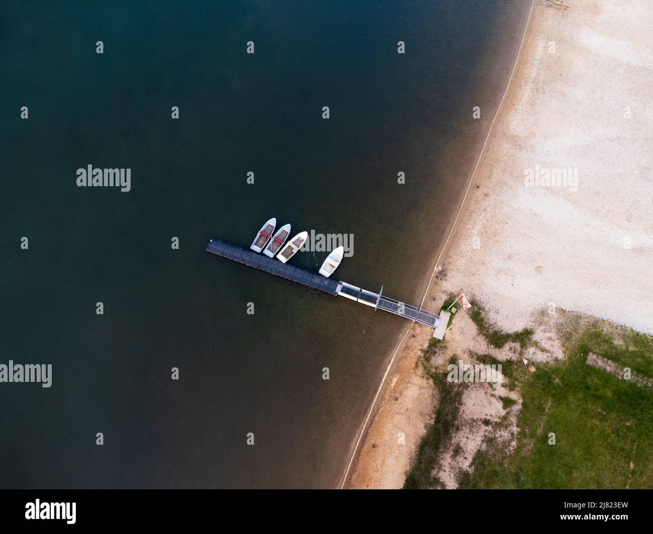 Aerial view of boats towed at a pier on Lake Olbersdorf Stock Photo