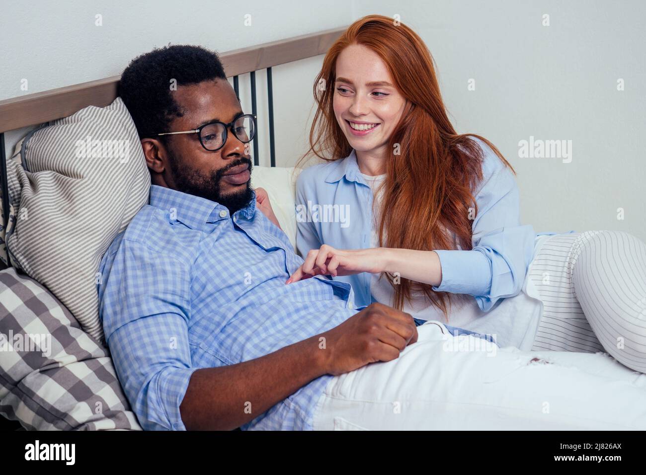 redhaired ginger caucasian happy female and multiethnic afro man
