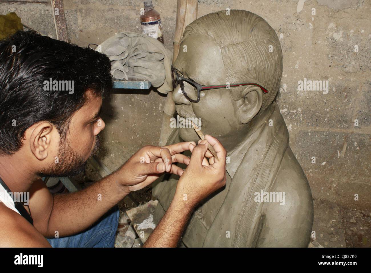 Man's hands making statue of clay. Stock Photo