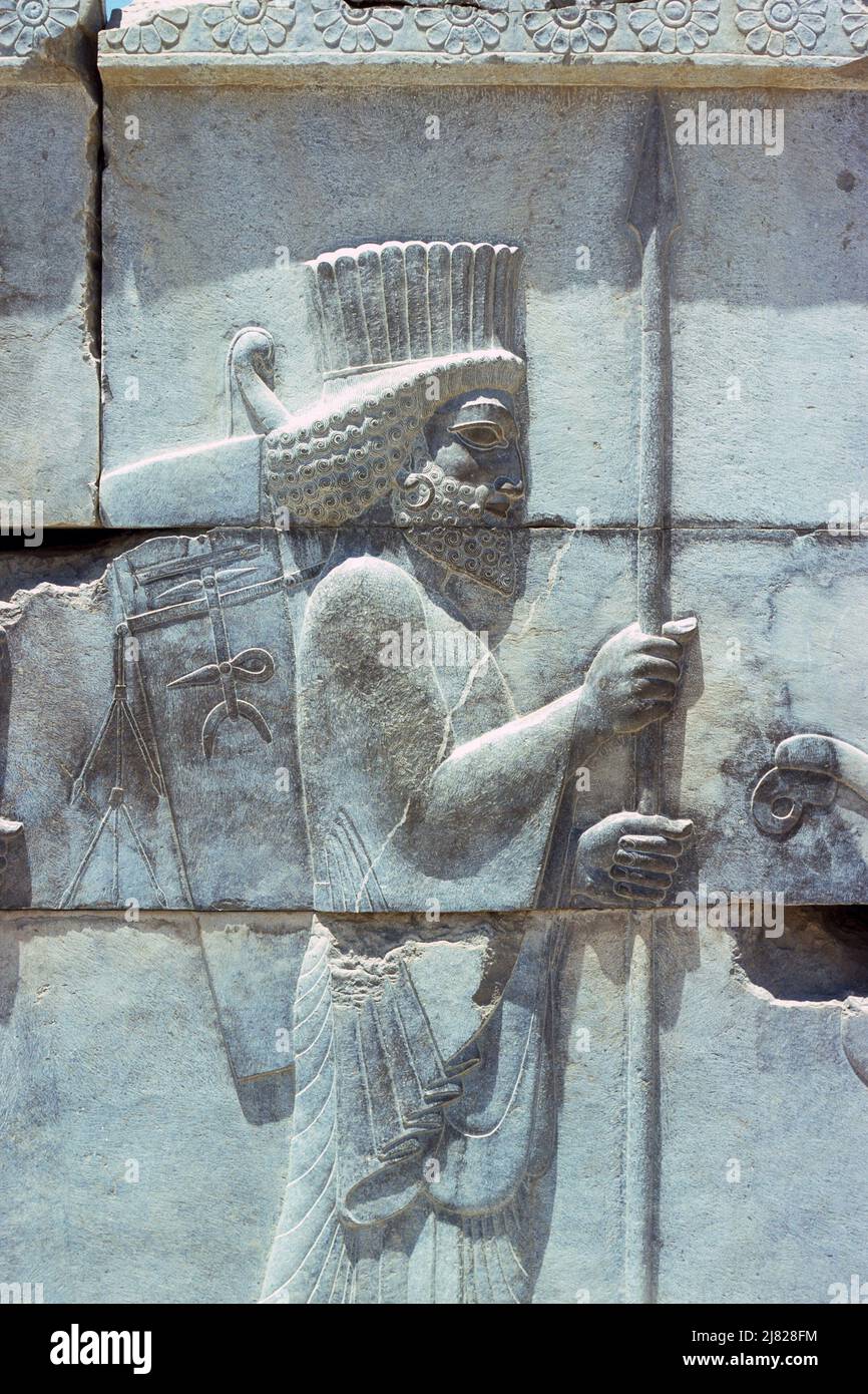 Persepolis, Iran - detail from wall relief showing Persian guards on main stairway of the Council Hall located in the ruins of the ancient city of Persepolis, ceremonial capital of the Achaemenid Empire, in Fars Province, Iran. Archive image taken in 1976 Stock Photo