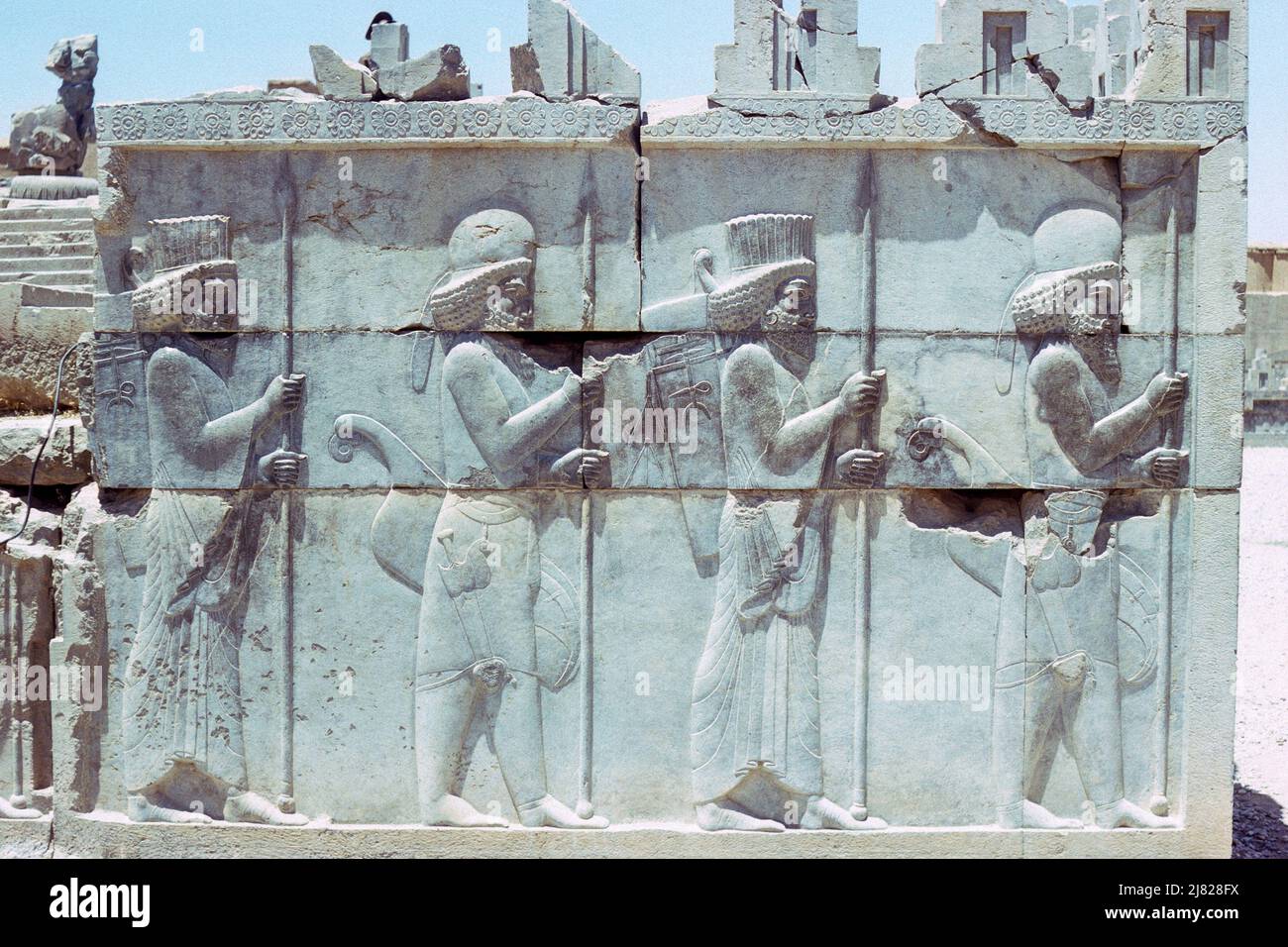 Persepolis, Iran - wall relief showing Persian guards on main stairway of the Council Hall located in the ruins of the ancient city of Persepolis, ceremonial capital of the Achaemenid Empire, in Fars Province, Iran. Archive image taken in 1976 Stock Photo