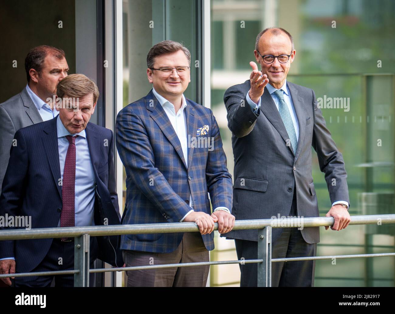 Berlin, Germany. 12th May, 2022. Ukrainian Foreign Minister Dmytro Kuleba stands next to Friedrich Merz (r), CDU Federal Chairman, and Johann Wadephul (l) and Florian Hahn before the discussion in the Bundestag. Credit: Michael Kappeler/dpa/Alamy Live News Stock Photo