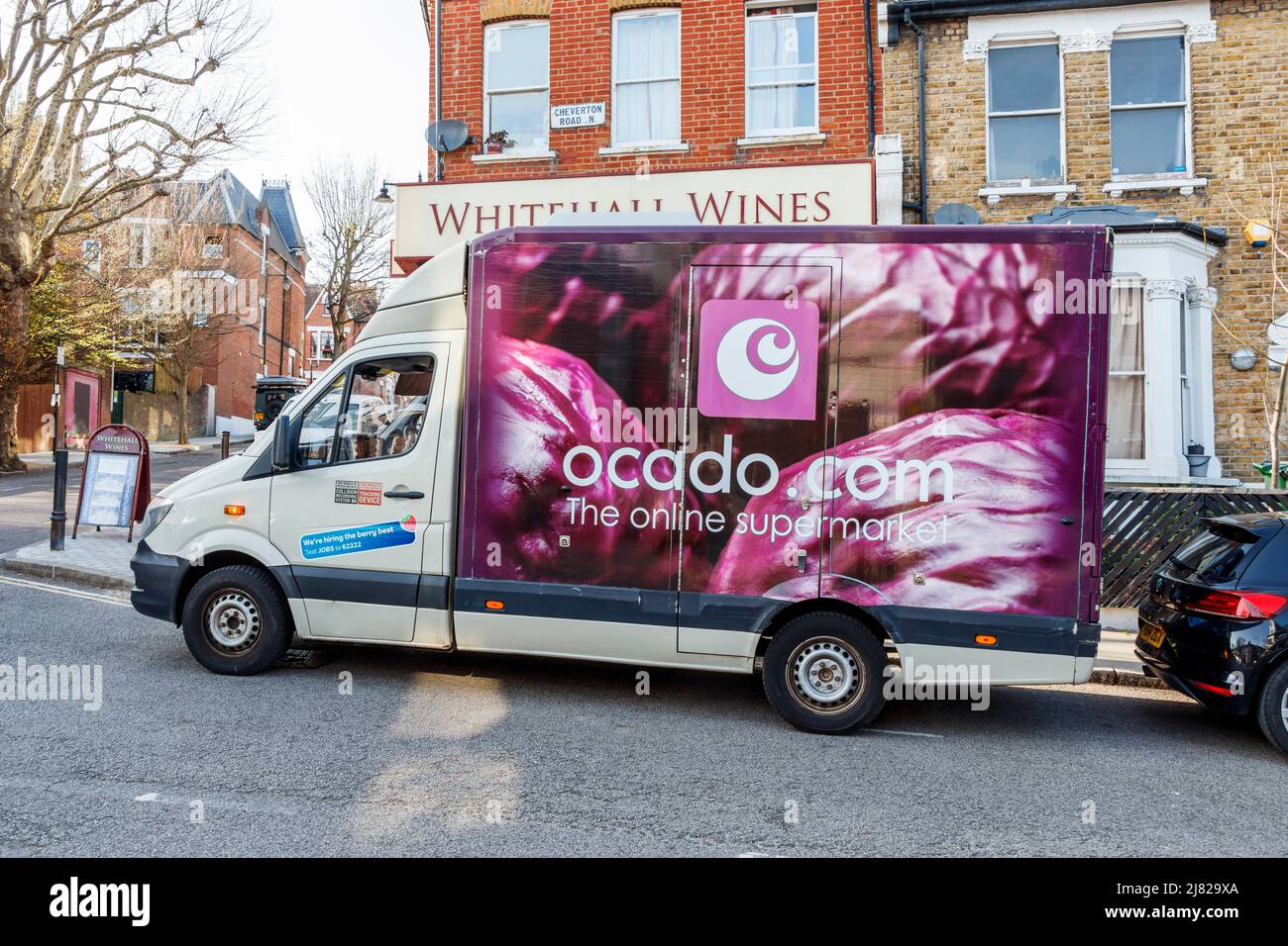 An Ocado van making deliveries in a residential area,  London, UK Stock Photo