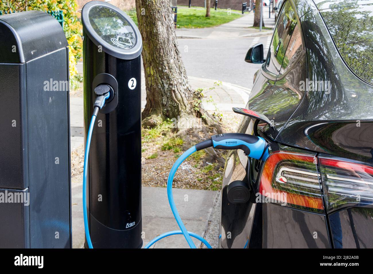 An electric vehicle recharging at a roadside recharging point,  London, UK Stock Photo
