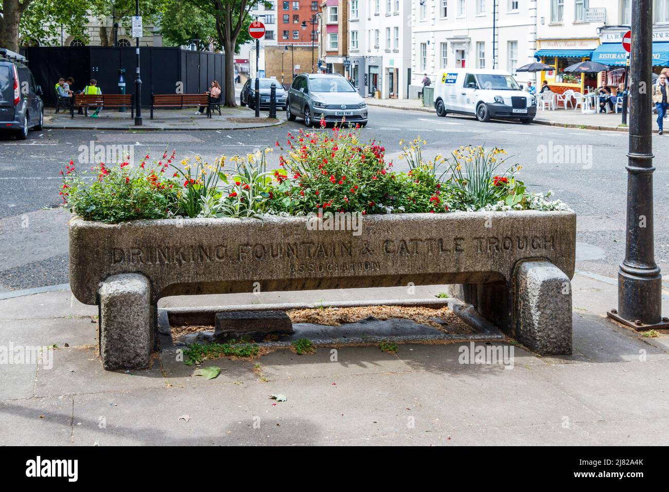 A trough of the Metropolitan Drinking Fountain and Cattle Trough Association planted with flowers, Clerkenwell, London, UK Stock Photo