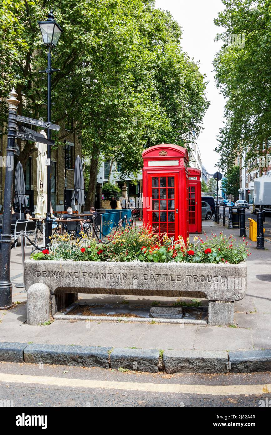 A trough of the Metropolitan Drinking Fountain and Cattle Trough Association planted with flowers, Clerkenwell, London, UK Stock Photo