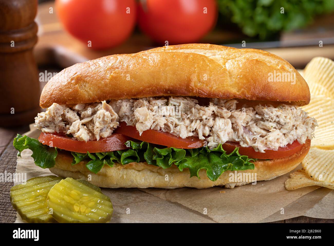 Closeup of a tuna salad, lettuce and tomato submarine sandwich with